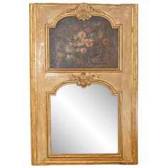 an ornate wooden mirror with flowers painted on it