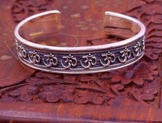 Excellent handmade 925 sterling silver Hindu mantra Aum bracelet, vintage antique stylish unisex gifting oxidized jewelry from Rajasthan india.Metal-925 sterling silver.Type-Bracelet/ kada.Size-Adjustable.Width-1.4 centimeters.Weight-42.470 grams approx.Finish-Oxidized.Stamped-925.Makes excellent gifting for birthday, wedding anniversary, mother's day, father's day Adjustable Silver Bracelets For Festivals, Adjustable Silver Jewelry For Rituals, Spiritual Toe Ring Jewelry For Festivals, Festivals Sterling Silver Cuff Bracelet With Oxidized Finish, Sterling Silver Oxidized Cuff Bracelet For Festivals, Spiritual Oxidized Finish Bracelets For Festivals, Spiritual Oxidized Bracelets For Festivals, Spiritual Bracelets With Oxidized Finish For Festivals, Silver Brass Spiritual Bracelets