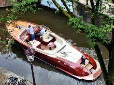 a man standing on the deck of a small boat