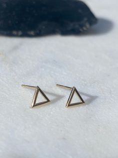 FIRST TIME DISCOUNT: USE CODE FIRSTTIME20 FOR 20% YOUR FIRST ORDER! ♡ ALL PACKAGING IS 100% RECYCLABLE, BIODEGRADABLE, OR MADE FROM 100% RECYCLABLE MATERIALS ♡ EARRING BACKS INCLUDED ALL ORDERS NOW COME WITH A GIFT BOX! These super cute 14kt Solid Gold outlined triangle earrings are a perfect accessory to your already gorgeous ears!  Listing comes with a choice of one single (1) earring or a pair (2) of earrings! Dimensions:  triangle: 5mm  post: 0.71mm x 9mm Materials:  14kt Solid Gold   ALL PACKAGING IS 100% RECYCLABLE, BIODEGRADABLE, OR MADE FROM 100% RECYCLABLE MATERIALS ♡ Want RUSH SHIPPING? Add this to your cart!  https://www.etsy.com/listing/774833735/rush-order-expedited-order-express Guarantees it goes out the same day as purchased! CARE INSTRUCTIONS:  Please be careful not to wea Bumble Bee Earrings, Triangle Stud Earrings, Earrings Triangle, Bee Studs, Triangle Earrings Stud, Gold Triangle, Studs Gold, Triangle Studs, Geometric Studs