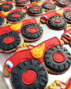 cookies decorated like cars and trucks are sitting on a table