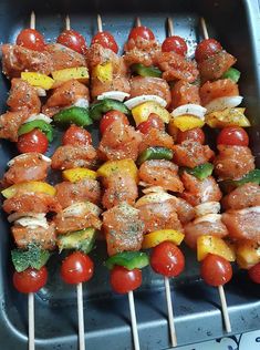 several skewers of meat and vegetables on a grill