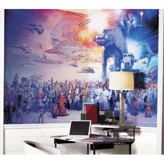 a room with a large mural on the wall next to a desk and laptop computer