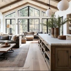 a living room filled with furniture and lots of windows