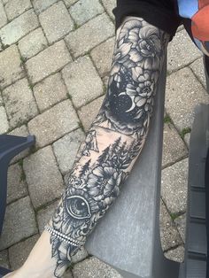 a person with a tattoo on their arm sitting on a bench