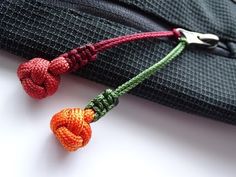 an orange and green knot is attached to a tie