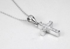 A token of faith. An 18k white gold cross showcases 11 stunning, princess cut diamonds, channel set. Each diamond is near colorless with 100% clean eye clarity. This pendant is a perfect size, not too small but big enough to be noticed and adored. This gorgeous diamond cross necklace is perfect for everyday use. It is an ideal gift to oneself or to someone you love! An inch 18K white gold cable chain is included with this diamond cross. Metal Purity: 18K White Gold (stamped behind bale: 18K) Set White Gold Cubic Zirconia Cross Necklace For Anniversary, Anniversary White Gold Cubic Zirconia Cross Necklace, Silver Cross Jewelry With Single Cut Diamonds, White Cross Pendant With Single Cut Diamonds, White Brilliant Cut Crucifix Jewelry, White Gold Diamond Cross Necklace Gift, White Cross Necklace With Brilliant Cut As Gift, White Gold Cross Necklace With Cubic Zirconia, Gift White Brilliant Cut Cross Necklace