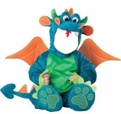 a blue dragon sitting on the ground with its legs crossed and eyes wide open, wearing a green t - shirt