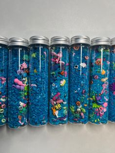 a row of blue jars filled with different types of sea creatures