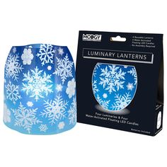 a blue and white lamp with snowflakes on it in front of a box