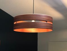 a wooden light fixture hanging from the ceiling