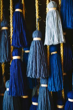 many blue and white tassels hanging from ropes