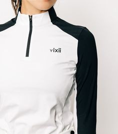 a woman wearing a white and black shirt with the word vixii on it