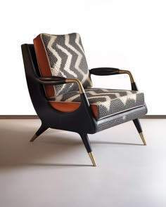 an animal print chair sitting in front of a white wall