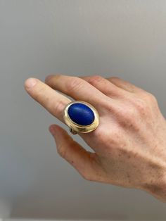 Vintage 14k Yellow Gold and Oval Lapis Lazuli Cabochon Ring Era: pre 1970's Condition: Excellent  Materials: 14K Yellow Gold and Oval Lapis Cabochon Size: US ring size 8.5 and sizable Carved Lapis Ring, Oval Gemstone Rings In Modernist Style, Modernist Oval Gemstone Rings, Modernist Oval Cabochon Rings, Collectible 14k Gold Oval Cabochon Ring, Modernist Hallmarked Oval Jewelry, Mid-century Oval Gold Jewelry, Cabochon Ring, Rings Statement