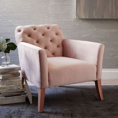 a pink chair sitting on top of a carpeted floor