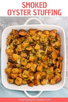 a white casserole dish filled with chicken and vegetables, topped with text that reads smoked oyster stuffing