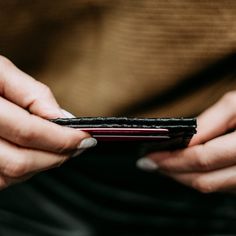 a person holding a cell phone in their hands