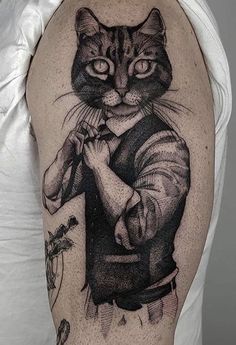 a man with a cat tattoo on his arm and shoulder, holding a knife in one hand