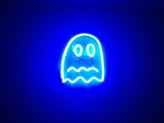 a blue neon sign with a ghost face on it