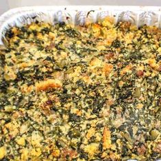 a casserole dish filled with spinach and cheese