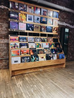 there is a display in the middle of this room with many pictures on it and bookshelves