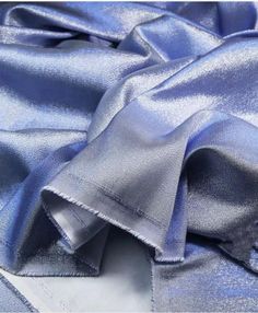 the fabric is shiny and blue in color