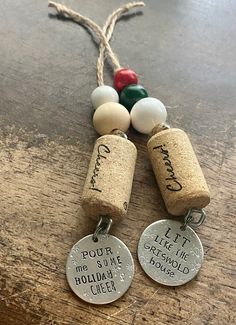 two wine corks with personalized tags attached to them