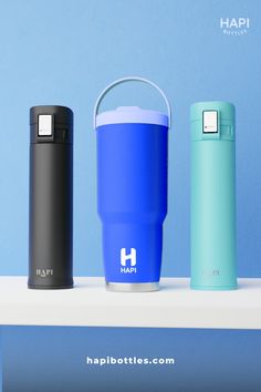 thermos are lined up next to each other in front of a blue wall