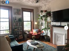 a living room filled with furniture and a flat screen tv mounted on the wall above a fire place