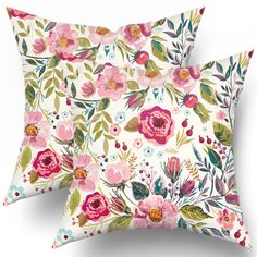 two pillows with floral designs on them, one is white and the other is pink