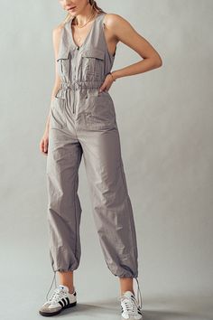 "Step into effortless chic with our V-Neck Zip-Up Midi Jumpsuit. This sleeveless tactical jumpsuit is crafted from 100% nylon, offering durability and style in one sleek package. Featuring a practical cargo design and an elastic waistband for comfort, this jumpsuit is perfect for festivals, summer adventures, vacations, cruises, and resort getaways. Available in a range of vibrant color options, it's the epitome of fashionable utility. Small (2/4), Medium (6/8), Large (10) *Measurements were taken laying flat Inseam for all size is 31-31.5\" Model is Wearing Size Small. Model: 5'9\"  32C bust, 25\" waist, and 36\" hips.  Color may vary slightly due to monitor resolution  100% Nylon NO REFUNDS-please check sizing Perfect, Soft Cozy top to wear with your Dainty Accessories. Active or lounge, Utility Style Sleeveless Jumpsuits And Rompers With Pockets, Fitted Cargo Style Jumpsuits And Rompers For Spring, Spring Cargo Style Fitted Jumpsuits And Rompers, Fitted Cargo Style Jumpsuits For Spring, Cargo Style Jumpsuits And Rompers For Spring, Sleeveless Khaki Jumpsuit With Pockets, Sleeveless Cotton Utility Jumpsuits And Rompers, Fitted Sleeveless Khaki Jumpsuits And Rompers, Sleeveless Khaki Jumpsuits And Rompers For Spring