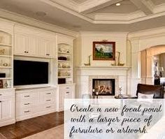 a living room filled with furniture and a flat screen tv on top of a fireplace