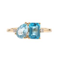 This blue topaz and diamond accent ring makes a stylish statement with luminous gemstones in an alluring modern design. Crafted in glistening 10K yellow gold, this ring features one emerald cut blue topaz artistically set alongside one pear-shaped blue topaz in eye-catching shades of blue, complemented by two round full cut diamond accents. | Blue Topaz and Diamond Accent Ring | 10K Yellow Gold | Size 6.5 | 2mm | Helzberg Diamonds Modern Yellow Gold Blue Topaz Ring, Modern Topaz Ring With Gemstone Accents For Anniversary, Modern Blue Topaz Ring With Diamond Accents, Measure Ring Size, Country Rings, Diamond Accent Ring, Helzberg Diamonds, Topaz Stone, Anniversary Bands