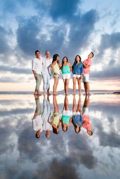 a group of people standing in front of a body of water