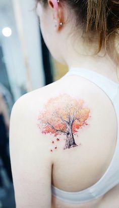 a woman with a tree tattoo on her back