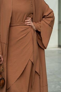 Introducing the Deluna three piece maxi lightweight abaya in rustic brown. This elegant and versatile design is perfect for any season and includes a long sleeve slip dress, apron piece, and a throw over abaya. The fabric is specially designed to resist wrinkles and the contrast brown color overlook seam at the edge of the abaya stands out.The abaya is super lightweight and flowy making it perfect for hot weather. The apron piece allows you to adjust the fit and the pattern of the abaya is not o Modest Activewear, Full Coverage Swimsuit, Dress Apron, Abaya Dress, Rustic Brown, Hot Weather, Three Piece, Active Wear Tops, Sleeve Designs