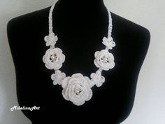 Ready to ship worldwide! Crochet necklace. Length: 53 cm (21.2 inches) + ties 34 cm (13.6 inches) on each side. Flower size: 4 small flowers: 3 cm (1.2 inches). 2 medium sized roses: 4.5 cm (1.8 inches). 1 large rose: 6 cm (2.4 inches). 100% cotton. Feel free to ask me any questions. Ready to ship in 2-3 business days. The list of items will be growing so stay tuned. Thank You. Elegant Adjustable Necklace With Handmade Flowers, Elegant Necklace With Handmade Flowers For Gifts, White Necklaces With Handmade Flowers As Gift, White Necklaces With Handmade Flowers For Gift, White Flower Bridal Necklace As Gift, Elegant White Flower Beaded Necklace, Elegant Handmade White Flower Necklace, Elegant Crochet Beaded Necklace As A Gift, Elegant Crochet Beaded Necklaces As Gift