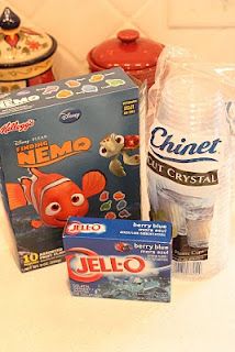 the ingredients to make nemo birthday cake are displayed on the counter top, including an ice cream container and candy bar wrapper