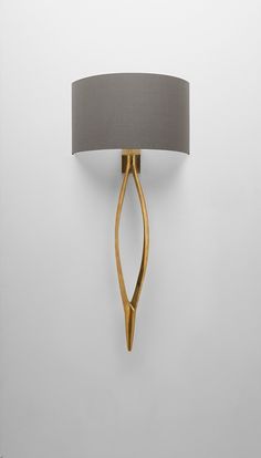 a wall light with a grey shade on it