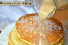 pancakes with syrup being poured onto them