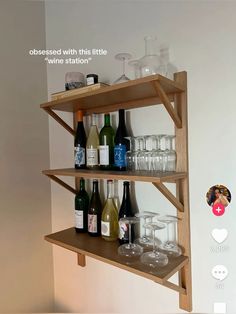 there are many bottles and glasses on the shelf