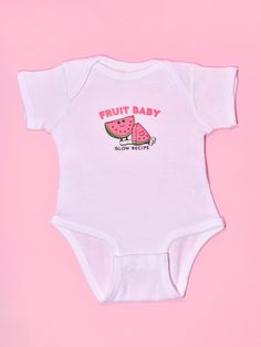 Introducing the fruit baby onesie: a limited edition & soft-as-clouds onesie for the fruit baby in your life. Complete with an adorable fruit graphic, bottom snaps, and lap shoulders that pull down easily, this onesie is ready for changes big or small--all while keeping your little one comfy. *All sales of Fruit Baby Onesie are final and are not eligible for refund or exchange. Pink Cotton Printed Onesie, Pink Printed Cotton Onesie, Cute Short Sleeve Bodysuit With Graphic Print, Pink Cotton Onesie With Graphic Print, Unisex Cute Onesie With Graphic Print, Pink Cartoon Print Onesie For Summer, Summer Pink Onesie With Cartoon Print, Cute Cotton Short Sleeve Bodysuit With Graphic Print, Playful Short Sleeve Onesie With Funny Print