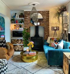 a living room filled with furniture and a fire place in the middle of the room