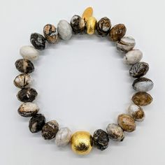 Made with a stunning combination of Wood Jasper and 24 karat Gold-plated Brass, this bracelet exudes elegance and sophistication. The organic patterns of the Wood Jasper add a touch of natural beauty, while the 24 karat Gold-plated Brass adds a luxurious touch. Ro & Gieo Wood Jasper and 24 karat Gold-plated Brass Bracelet Bead size - 10 - 11.5 mm Bracelet length - 7 inches If you want your bracelets in a different size than 7 inches, we are more than happy to accommodate your request. Please sim Gold Agate Beaded Bracelets With Gemstones, Gold Bracelets With Agate And Natural Stones, Gold Gemstone Bracelets For Healing, Elegant Gold Stretch Bracelet With Natural Stones, Gold Agate Bracelet With Gemstone Beads, Gold Agate Gemstone Beaded Bracelets, Gold Bracelets With Natural Round Beads, Gold Stretch Bracelet With Gemstones As Gift, Luxury Gold Bracelets With Gemstone Beads