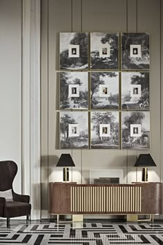 a living room with black and white flooring and pictures on the wall above it