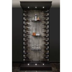 a wine rack with several bottles and glasses on it in a room that has black walls