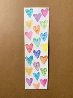 a piece of paper with watercolor hearts on it