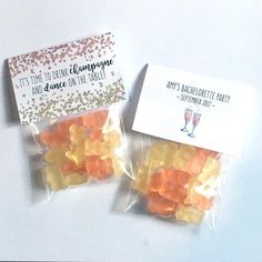 two bags filled with gummy bears sitting on top of a white table next to each other