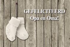 two pairs of white socks sitting on top of a wooden floor next to the words geeflicterd opa en oma